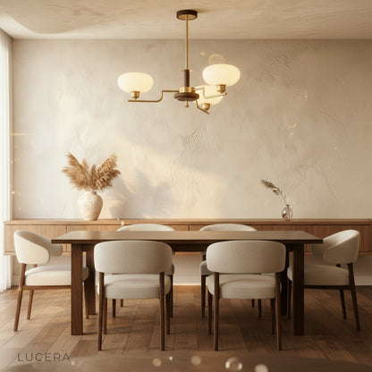 Eronix chandelier in a bright kitchen island setting with wooden stools and brass fixtures