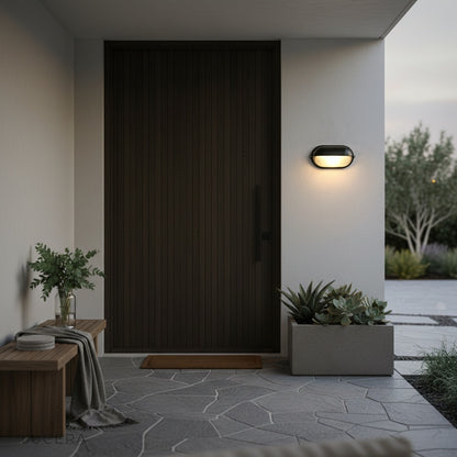 Acolyte lamp glowing softly beside a garage door with concrete texture