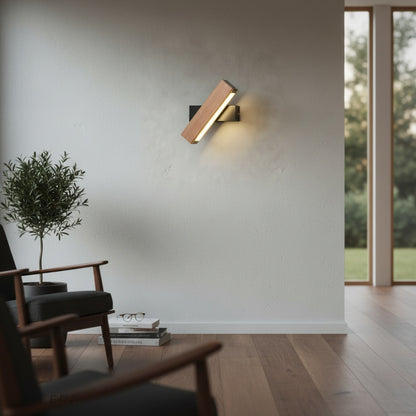 Quodlibet Wall Lamp glowing at dusk in cozy reading nook with wooden shelf and books