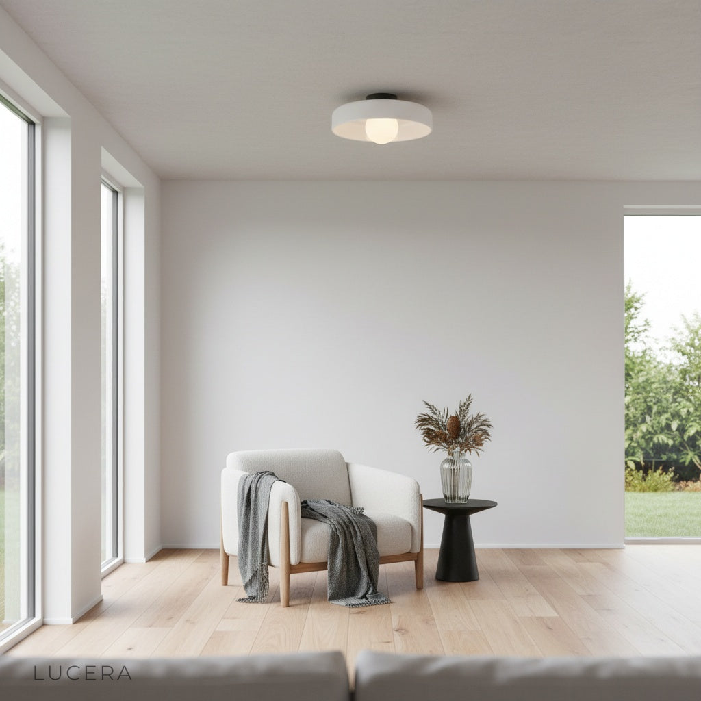 Madder ceiling light in a stylish dining area, opal glass shade glowing above a table set for dinner