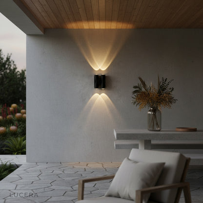xylophone wall light casting upward and downward beams on brick wall