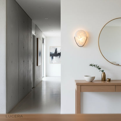 Close-up of Borealis sconce showing sleek minimalist metal details and alabaster texture