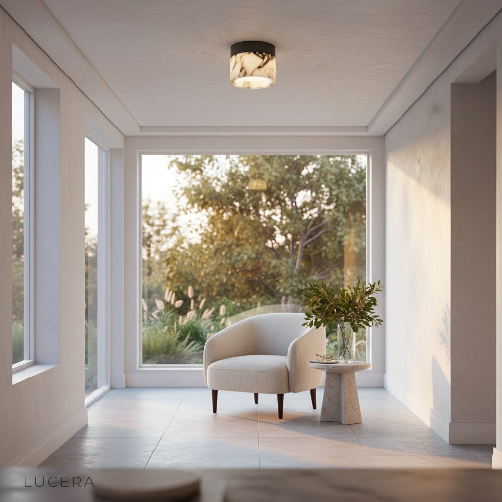 Nighttime lifestyle shot of Lucera Raphael marble ceiling light casting soft pool of light on floor