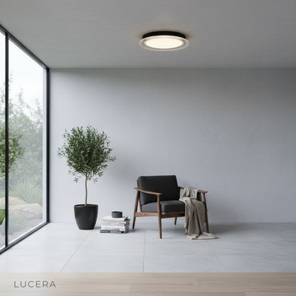 Zelo ceiling light glowing softly in modern bedroom with neutral bedding and low ceiling
