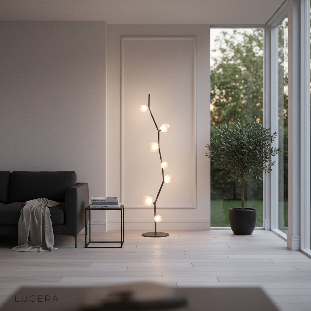 Sculptural floor lamp casting ambient glow in cozy reading corner at dusk
