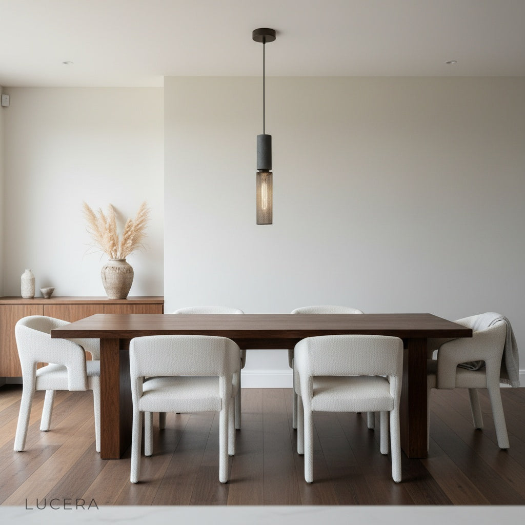 Alternate angle of Ridge Pendant Light showing full cylindrical silhouette and hanging cord against white wall