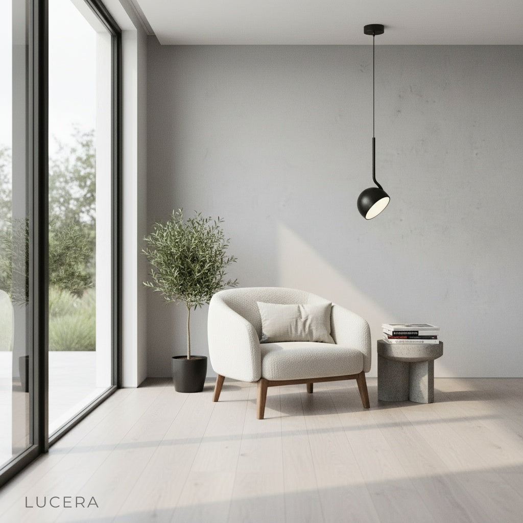 Sancerre pendant light focused downward over a cozy workspace desk with notebook