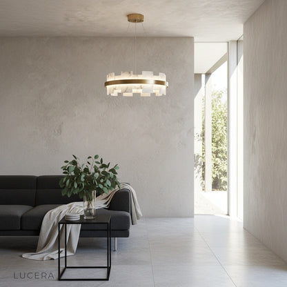 Ablution chandelier in brushed copper finish with soft ambient light casting shadows on neutral wall