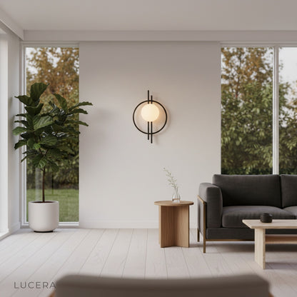 Leander Wall Lamp illuminating a cozy office desk at dusk