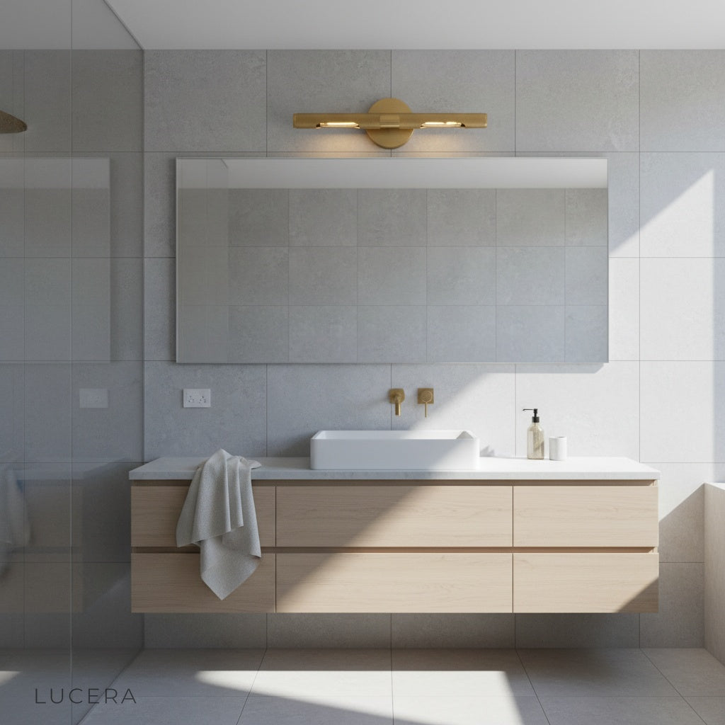 Keziah brass mirror light with rotatable arms illuminating a chic dressing table