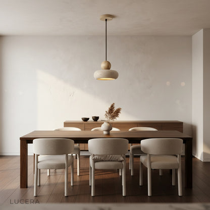 Evening shot of Mensa Pendant Light casting warm glow over wooden dining table