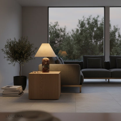 Xerophytic Table Lamp illuminating dark bookshelf with warm light in evening