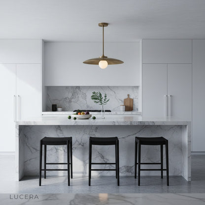 Brass Sylvaine pendant light in a contemporary living space with neutral decor