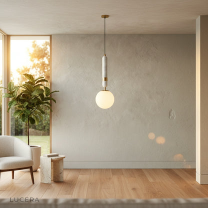Marble and copper pendant light illuminating cozy reading corner