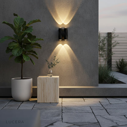 warm ambient glow from xylophone sconce lighting up a garden at dusk