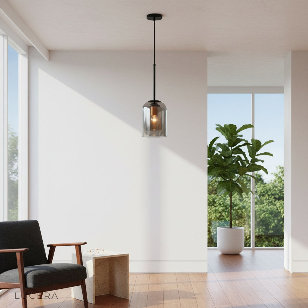 Theodora pendant light glowing warmly over a cozy reading nook with exposed brick wall