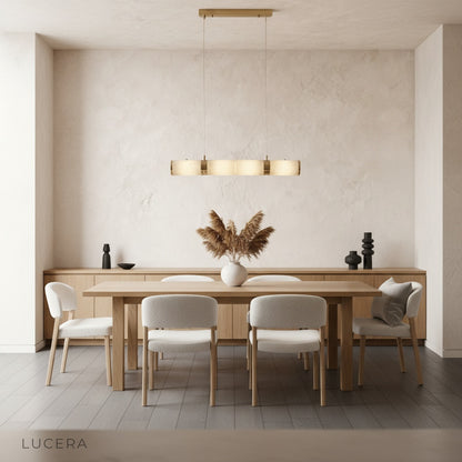 Evening shot of alabaster pendant light casting cozy shadows in minimalist kitchen