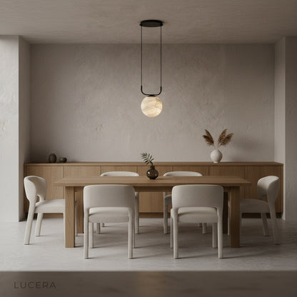 Bibelot pendant lamp casting ambient light in entryway at dusk
