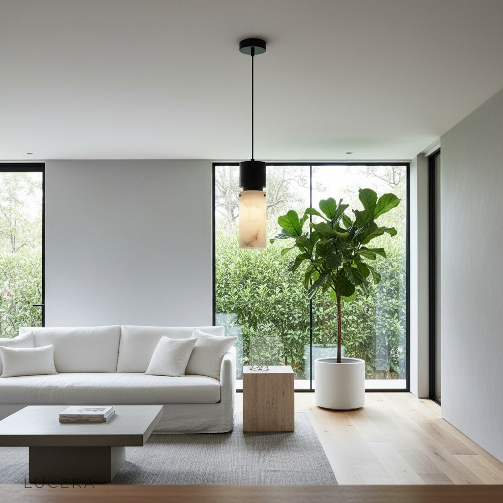 Hematite pendant light illuminating a kitchen counter at dusk with warm ambient light and reflective copper accents