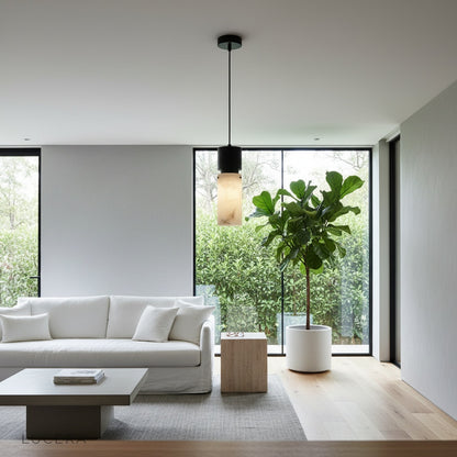 Hematite pendant light illuminating a kitchen counter at dusk with warm ambient light and reflective copper accents