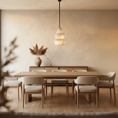 Fillet Alabaster pendant light glowing in dark moody bedroom corner with sheer curtains