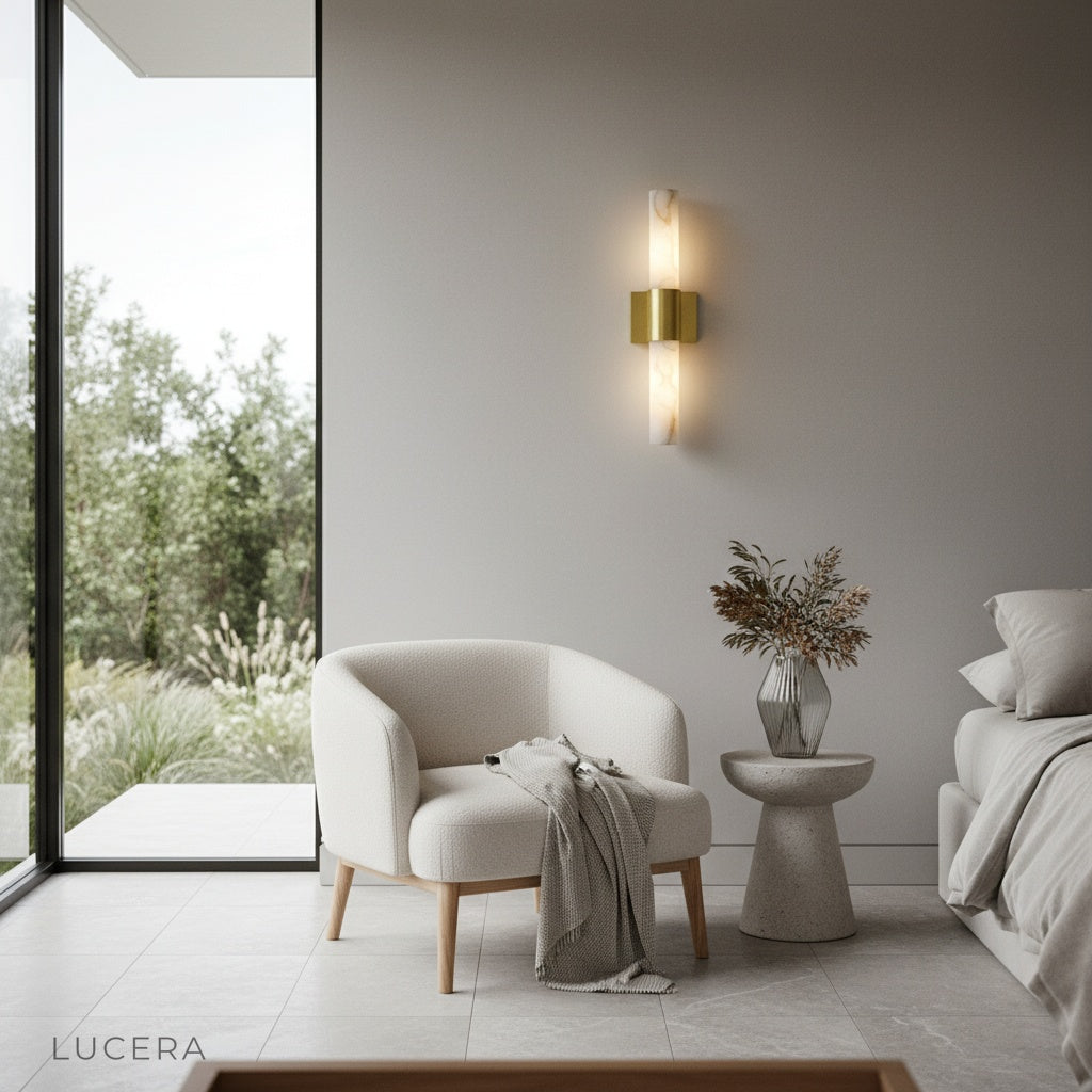Umbra Alabaster wall sconce above a bedside table with soft ambient lighting