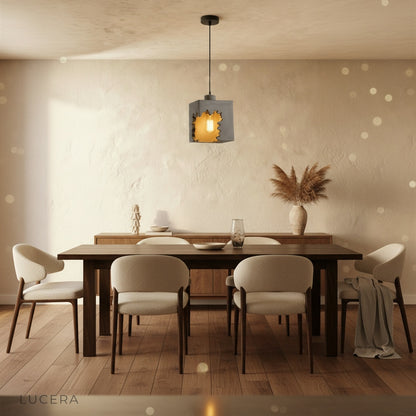 Pair of Enthrall concrete pendant lights hanging above a breakfast bar in contemporary kitchen