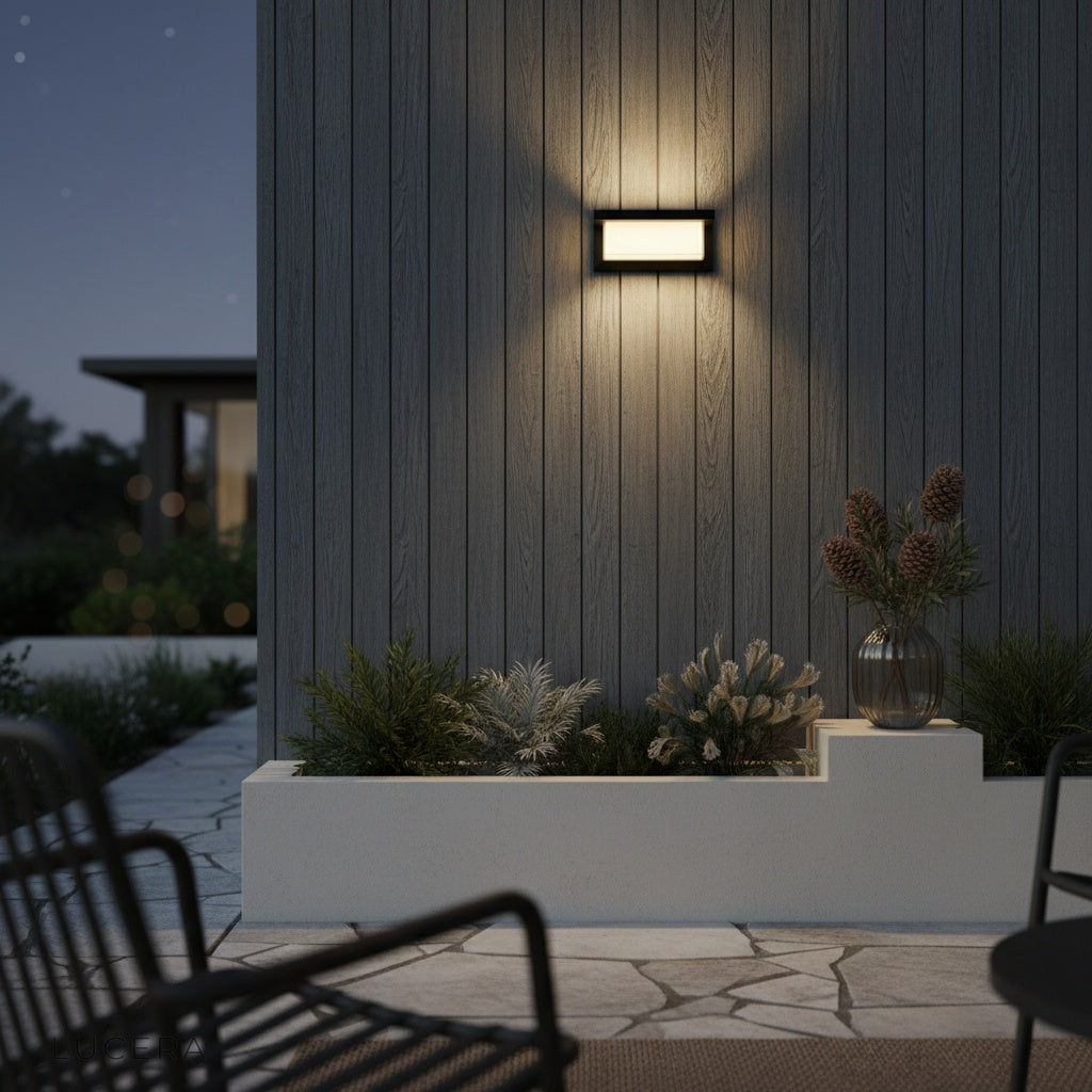 pair of Leonora outdoor sconces flanking a wooden garage door in soft evening light
