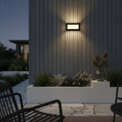 pair of Leonora outdoor sconces flanking a wooden garage door in soft evening light