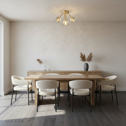 Crylo ceiling light casting warm ambient glow in dining room at dusk