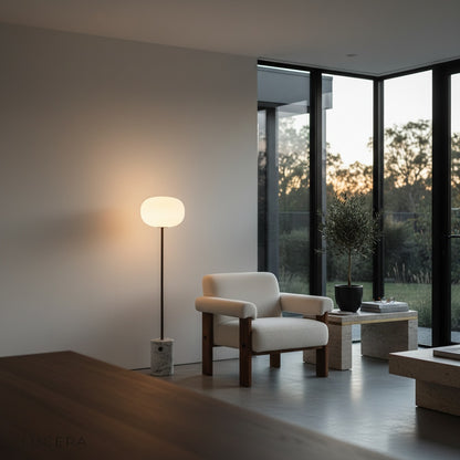Quentin Floor Lamp silhouette against wall with soft golden halo