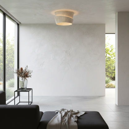Eulalia flush mount fixture illuminating a reading corner with armchair and lamp