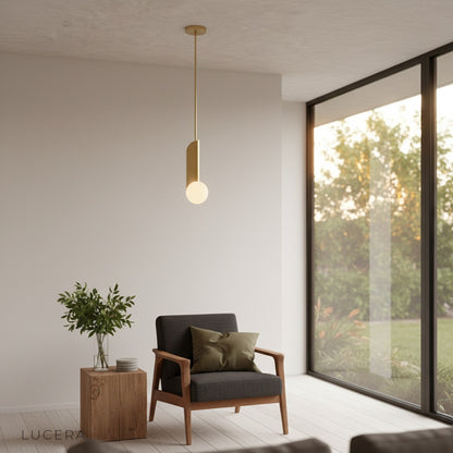 Yancy pendant light at dusk casting soft diffused glow in a minimalist living room