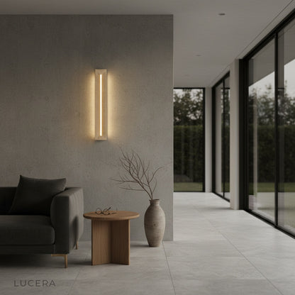 Yves wall lamp mounted in hallway casting soft diffused glow at dusk