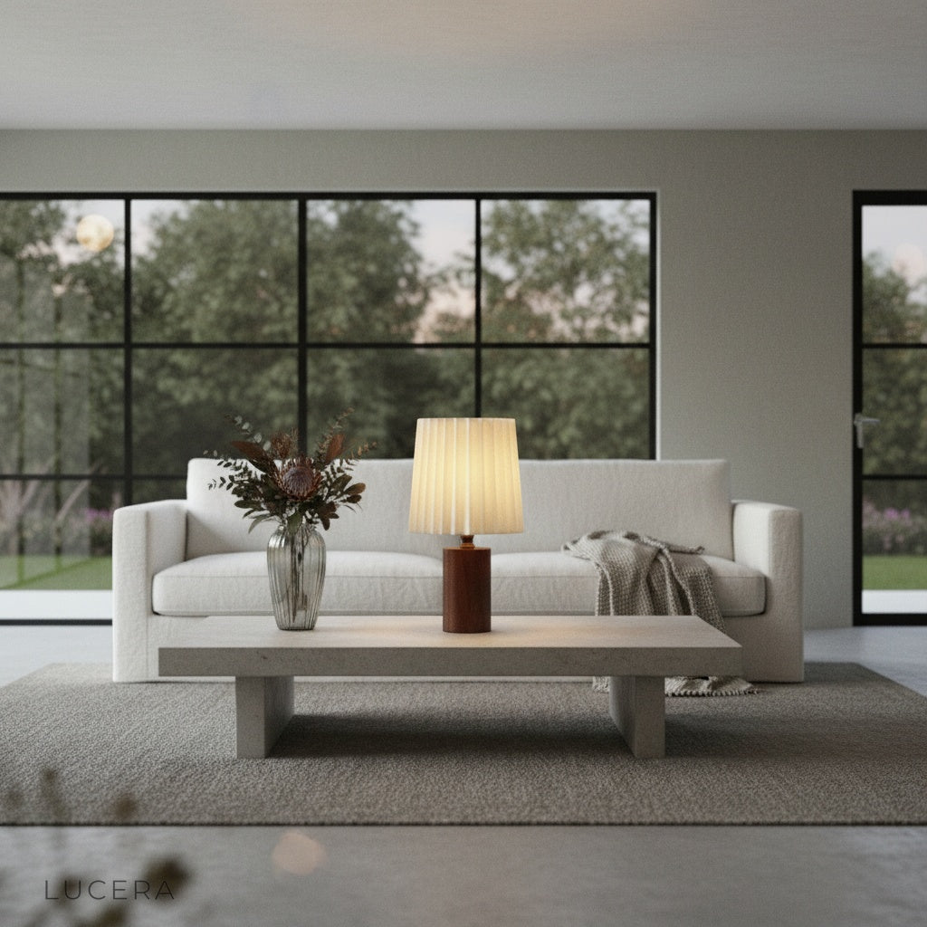 Nighttime lifestyle shot of Pandora Table Lamp on entryway table with stone wall background and warm inviting glow