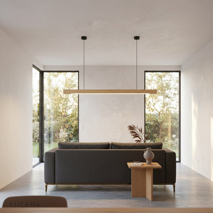 nighttime lifestyle shot of Kirsch pendant light glowing above a bedside table in bedroom
