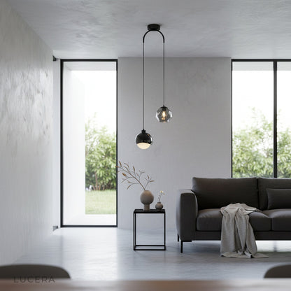 Black Vale pendant light above an entryway console, ambient warm lighting, stylish home