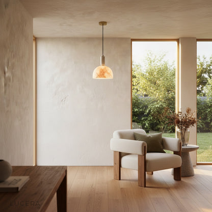 evening lifestyle shot of Midas alabaster pendant light creating calming atmosphere in reading nook