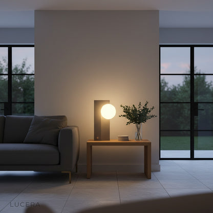 industrial style concrete lamp illuminated at dusk on bedside nightstand