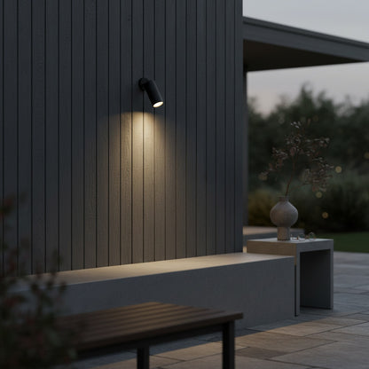angled Gaea spotlight highlighting a potted plant on a minimalist balcony at night