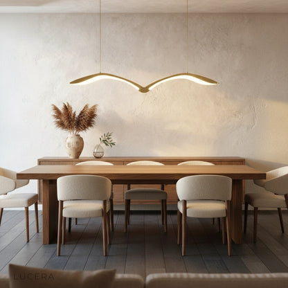linear chandelier paired with neutral decor in a modern bedroom corner