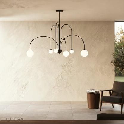 Unico Chandelier casting romantic glow in bedroom with neutral tones