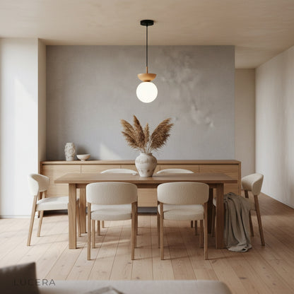 scandinavian dining room with kaleidoscope pendant light casting warm ambient glow
