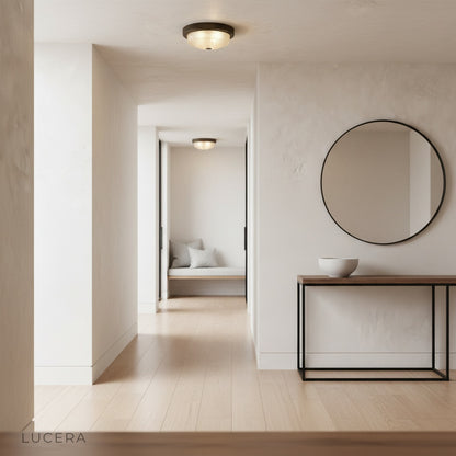 Veneration ceiling light at dusk in modern entryway with bronze accents and warm welcoming glow