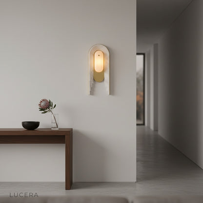Fulgid wall lamp illuminated at night beside a cozy bed with soft ambient glow