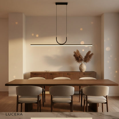 Honeysuckle linear pendant light above a kitchen breakfast bar, sleek silhouette contrasting with wooden stools