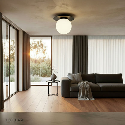 Bijou ceiling light in minimalist bedroom with soft evening lighting and gold accents