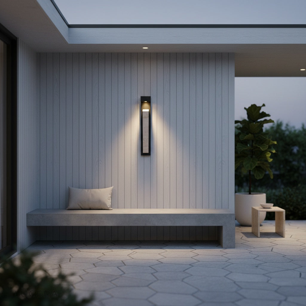 Elisk wall lamp in dark ambient bedroom with sculptural stone silhouette illuminated