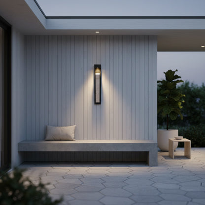 Elisk wall lamp in dark ambient bedroom with sculptural stone silhouette illuminated