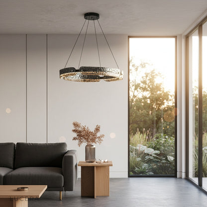 evening shot of chandelier glowing above minimalist bedroom reading area